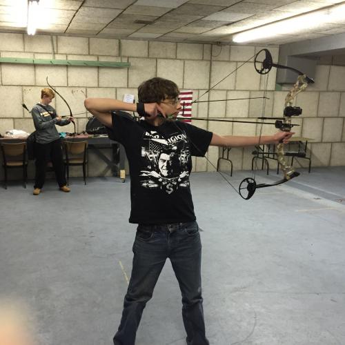 Youth club member shooting a bow